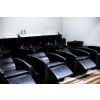 RIO G-046 shampoo backwash unit with near-flat reclining chair and kick-out footrest, black upholstery, white stationary ceramic bowl with built-in headrest and gel neckrest